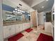 Bright bathroom featuring double sinks, granite countertops, and large vanity mirror at 1211 Bourbon St, Pahrump, NV 89048