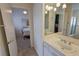 Bright bathroom featuring tile floors, a sink, and view to bedroom at 1211 Bourbon St, Pahrump, NV 89048