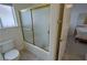 Clean bathroom showing tile floors, bathtub, and sliding glass door at 1211 Bourbon St, Pahrump, NV 89048