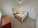 Comfortable bedroom with carpet flooring, a bed, dresser and closet at 1211 Bourbon St, Pahrump, NV 89048
