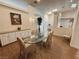 Inviting dining room with a glass table, striped chairs, and natural lighting at 1211 Bourbon St, Pahrump, NV 89048