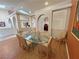 Sunlit dining area showcases a glass table, striped chairs, and elegant arched doorways at 1211 Bourbon St, Pahrump, NV 89048