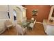 Spacious dining room with a modern glass table, striped chairs, and stylish decor at 1211 Bourbon St, Pahrump, NV 89048