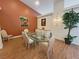Bright dining room with a glass table, striped chairs, and elegant decorations at 1211 Bourbon St, Pahrump, NV 89048