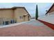 Side exterior view of the home with landscaping and central air conditioning at 1211 Bourbon St, Pahrump, NV 89048