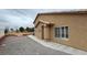 Exterior view of home showing gravel landscaping, stucco walls, and small yard at 1211 Bourbon St, Pahrump, NV 89048