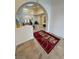 Open foyer with arched doorways, tile flooring, and decorative area rug at 1211 Bourbon St, Pahrump, NV 89048