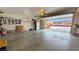 Spacious garage with built in shelving, window, and open door at 1211 Bourbon St, Pahrump, NV 89048