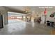 Large garage with access to a half bath and an open garage door at 1211 Bourbon St, Pahrump, NV 89048
