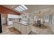Spacious kitchen with white cabinetry, center island, and natural light from skylights at 1211 Bourbon St, Pahrump, NV 89048