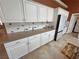 Kitchen boasts custom cabinetry with pull-out drawers, granite countertops, and modern stainless appliances at 1211 Bourbon St, Pahrump, NV 89048