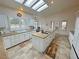 Bright and open kitchen features white cabinets, an island cooktop, and a breakfast nook at 1211 Bourbon St, Pahrump, NV 89048