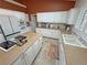 The kitchen features white cabinets, stainless appliances, granite countertops, island cooktop, and breakfast nook at 1211 Bourbon St, Pahrump, NV 89048