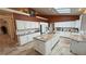 Bright, spacious kitchen with white cabinets, an island with a sink, and tiled floors at 1211 Bourbon St, Pahrump, NV 89048