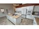 Well-appointed kitchen features an island with a cooktop, granite countertops, and modern appliances at 1211 Bourbon St, Pahrump, NV 89048