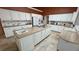 A large kitchen with white cabinets, granite countertops, and an island with a sink provides ample prep and storage space at 1211 Bourbon St, Pahrump, NV 89048