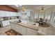 Bright kitchen includes granite countertops, modern appliances, a central island with prep sink, and a breakfast nook at 1211 Bourbon St, Pahrump, NV 89048