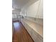 Bright laundry room with white cabinets, wood floors, and lots of counter space at 1211 Bourbon St, Pahrump, NV 89048