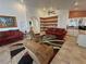 Inviting living room featuring plush sofas, a ceiling fan, and a cozy reading nook with shelving at 1211 Bourbon St, Pahrump, NV 89048