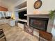 Comfortable living area with a fireplace, built-in shelving, and a view into the adjoining wet bar at 1211 Bourbon St, Pahrump, NV 89048