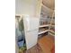 View of pantry storage space with mini fridge and shelving filled with various items at 1211 Bourbon St, Pahrump, NV 89048