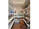 Well-organized walk-in pantry featuring multiple shelves filled with food and household items at 1211 Bourbon St, Pahrump, NV 89048