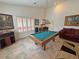 Game room with a pool table, framed artwork, and plantation shutters for natural lighting at 1211 Bourbon St, Pahrump, NV 89048