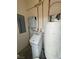 Utility room featuring a water softener, water heater, and solar power control panel at 1211 Bourbon St, Pahrump, NV 89048