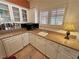 Charming wet bar area with white cabinetry, granite countertops, and a sink, perfect for entertaining at 1211 Bourbon St, Pahrump, NV 89048