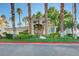 Beautiful clubhouse surrounded by lush landscaping, towering palm trees, and meticulous grounds at 1401 Red Crest Ln # 201, Las Vegas, NV 89144