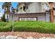 Elegant Red Bluffs community entrance sign surrounded by lush green landscaping and stone accents at 1401 Red Crest Ln # 201, Las Vegas, NV 89144