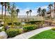 Inviting community pool area with lush landscaping, palm trees, and a secure fence at 1401 Red Crest Ln # 201, Las Vegas, NV 89144