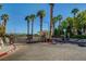 Gated community entrance framed by palm trees and lush greenery at 1401 Red Crest Ln # 201, Las Vegas, NV 89144
