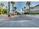 Community entrance with palm trees and meticulously maintained landscaping at 1401 Red Crest Ln # 201, Las Vegas, NV 89144
