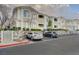 Apartment building with balconies, rock wall landscaping, and ample parking spaces at 1401 Red Crest Ln # 201, Las Vegas, NV 89144