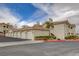Exterior view of the community with multiple garages and lush landscaping; well-maintained at 1401 Red Crest Ln # 201, Las Vegas, NV 89144