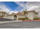 Exterior view of the community with multiple garages and lush landscaping; well-maintained at 1401 Red Crest Ln # 201, Las Vegas, NV 89144