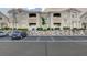 Apartment building with parking and rock wall landscaping, and visible unit numbers at 1401 Red Crest Ln # 201, Las Vegas, NV 89144