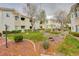 Manicured community lawn with mature trees and natural rock features add to the curb appeal at 1401 Red Crest Ln # 201, Las Vegas, NV 89144