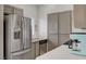 Bright kitchen with stainless steel refrigerator, double sink, and light cabinets at 1401 Red Crest Ln # 201, Las Vegas, NV 89144