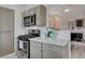 Well-equipped kitchen with stainless steel stove, range hood, and white countertops at 1401 Red Crest Ln # 201, Las Vegas, NV 89144