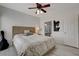 Main bedroom with large bed, ensuite bathroom, guitar, and abstract artwork at 1401 Red Crest Ln # 201, Las Vegas, NV 89144