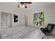Main bedroom featuring a large bed, ensuite bathroom, and brightly colored abstract artwork at 1401 Red Crest Ln # 201, Las Vegas, NV 89144