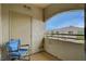 Outdoor patio area with a comfortable chair, providing a relaxing view of the community at 1401 Red Crest Ln # 201, Las Vegas, NV 89144