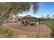 Landscaped backyard features a covered pergola, potted plants, and gravel ground cover at 1580 Rosita Dr, Las Vegas, NV 89123