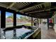 Enjoy the backyard featuring a covered patio, relaxing hot tub, and a refreshing swimming pool at 1580 Rosita Dr, Las Vegas, NV 89123