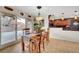 Dining area with wooden table, sliding glass doors, and direct access to the kitchen at 1580 Rosita Dr, Las Vegas, NV 89123