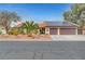Charming single-story home featuring a two-car garage, solar panels, desert landscaping, and a red tile roof at 1580 Rosita Dr, Las Vegas, NV 89123