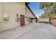 Side exterior with concrete driveway, utility access, and rear shed access at 1580 Rosita Dr, Las Vegas, NV 89123