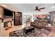 Spacious living room featuring a fireplace, ceiling fan, and tile flooring throughout the house at 1580 Rosita Dr, Las Vegas, NV 89123